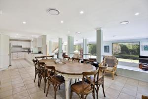 a kitchen and dining room with a table and chairs at Floriel - By Berry Getaways in Berry