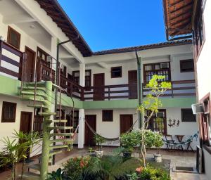 a building with a spiral staircase in a courtyard at Pousada Paraíso Ilha Grande in Abraão