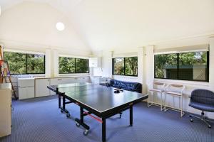 a living room with a ping pong table and chairs at Floriel - By Berry Getaways in Berry