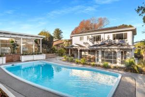 a swimming pool in front of a house at Berry Vista - By Berry Getaways in Berry