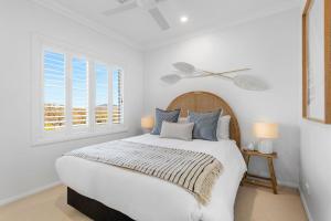 a white bedroom with a large bed and a window at Berry Vista - By Berry Getaways in Berry +16 photos