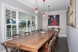 a dining room with a wooden table and chairs at Possum Gully Lodge -By Berry Getaways in Berry