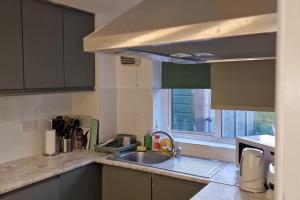 a kitchen with a sink and a window at Serene Inn Near Bletchley Park in Bletchley