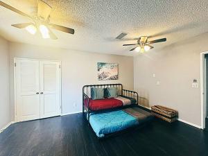 a room with a bed and a ceiling fan at Spacious & Immaculate Haven near Downtown SD in San Diego
