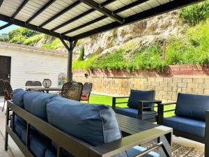 a patio with blue couches and a table and chairs at Spacious & Immaculate Haven near Downtown SD in San Diego
