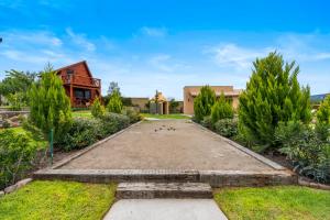 a courtyard with a house and trees at Cabañas Xidó San Miguel in San Miguel de Allende