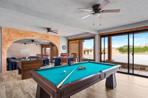 a pool table in a living room with a ceiling fan at Cabañas Xidó San Miguel in San Miguel de Allende +75 photos