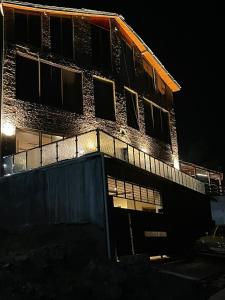 a brick building with a fence in front of it at Luxury patriata house murree in Patriata