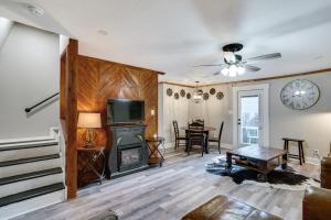 a living room with a fireplace and a table at Pet-Friendly Granbury Home with Yard, Near Downtown! in Granbury