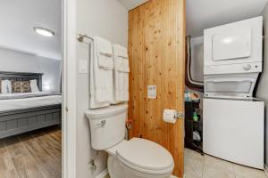 a small bathroom with a toilet and a bed at The Barracks Forest Escape Dog Friendly BBQ in Colorado Springs +18 photos