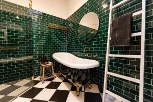 a green tiled bathroom with a sink and a mirror at Mabel's Cottage - By Berry Getaways in Berry +23 photos