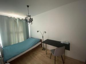 a bedroom with a bed and a desk and a table at AKS Akademicka 8b przy Onkologii in Bydgoszcz