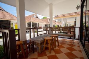 a patio with a table and chairs on a balcony at หาดทรายขาวรีสอร์ท in Bang Saphan