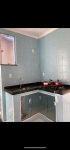 a kitchen with a sink and a counter top at Condomínio paixão 4 in Aparecida