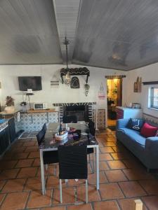 a living room with a couch and a table at Tropical Dream Farm in Vouzela