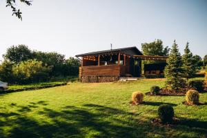 a house on a hill with a grassy yard at Eco House Uman in Umanʼ