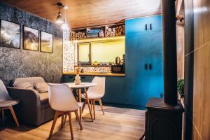a living room with a table and chairs and a couch at Eco House Uman in Umanʼ