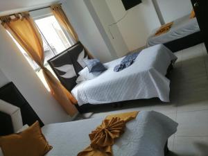 Postel nebo postele na pokoji v ubytování Hotel Linaje Popayán