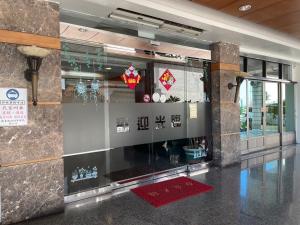 a lobby of a building with a wall with decorations at Fu Men Hotel in Pingtung City