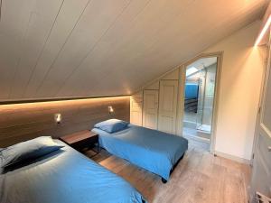 a bedroom with two beds and a window in it at Appartement 5 pièces avec balcon et garage à Méribel - FR-1-180-624 in Les Allues