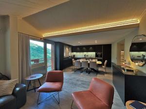 a living room with chairs and a dining room at Appartement 5 pièces avec balcon et garage à Méribel - FR-1-180-624 in Les Allues