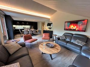 a living room with a couch and a table at Appartement 5 pièces avec balcon et garage à Méribel - FR-1-180-624 in Les Allues