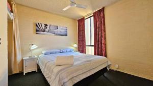 a bedroom with a bed and a window at Riverview Holiday Apartment 49 - Kalbarri WA in Kalbarri