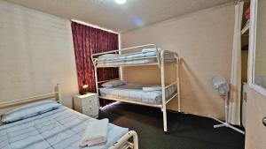 a room with two bunk beds and a window at Riverview Holiday Apartment 49 - Kalbarri WA in Kalbarri