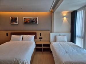 Postel nebo postele na pokoji v ubytování The solid residence - Elbon the stay by haeundae
