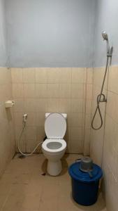 a bathroom with a toilet and a shower at DEWI HOTEL in Kuta Lombok