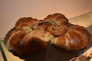 a plate of croissants and pastries on a plate at Lucky 8 Hotel in Ilford +44 photos
