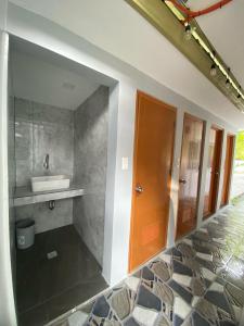 a bathroom with a sink and a mirror at Casa D' Hiyas Whole House Homestay in Panglao in Panglao