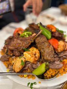 a plate of food with meat and vegetables on a table at AAC in Chennai