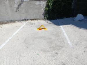 a caution sign on the ground in a parking lot at Mihail apartments in Năvodari