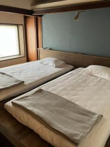Postel nebo postele na pokoji v ubytování おやど生結 iyu
