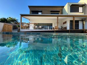 a swimming pool in front of a house at Villa Eclats Panoramiques in Saint-Pierre