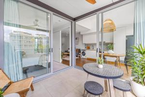 a living room with a table and chairs at Executive Beachside Getaway in Maroochydore
