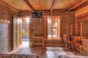 a room with a table and a window and a television at Hotel Finca Belén in Tlaxco de Morelos