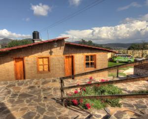 a small house with a car parked in front of it at Hotel Finca Belén in Tlaxco de Morelos