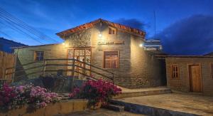 a stone house with lights on the side of it at Hotel Finca Belén in Tlaxco de Morelos
