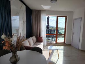 a living room with a couch and a table at APART SUNNY BAY a SUNNY BEACH in Sunny Beach