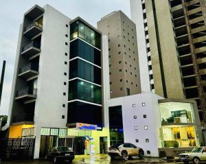 a large building with cars parked in front of it at Iconic Apartments in Addis Ababa