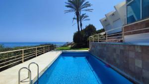 a swimming pool on the side of a house at La Rocalla in Manilva