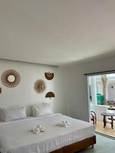 a bedroom with a bed with two towels on it at Gee Resort in Ko Tao