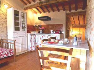 a kitchen with a counter and a table with chairs at Agriturismo I Pitti in Serravalle Pistoiese