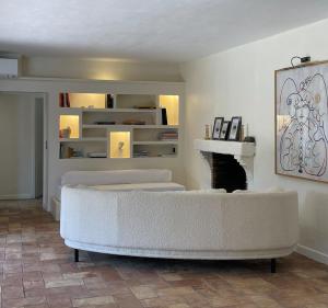 a living room with a white couch and a fireplace at Maison provençale in Grimaud +13 photos