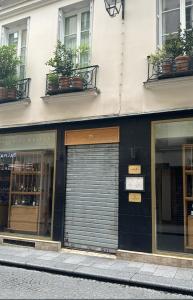 a building with two garage doors on a street at Historic paris charme in Paris