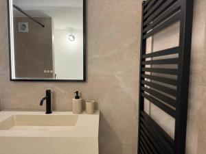 a bathroom with a sink and a mirror at Studio design - Coup de coeur in Antibes