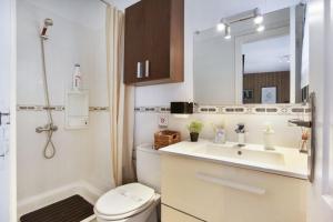 a bathroom with a toilet and a sink and a mirror at Estudio La Laguna in La Laguna +18 photos