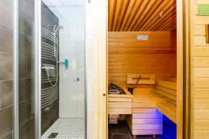 a sauna with a shower and a sink at Sissi Park Haus im Ennstal - Schladming in Haus im Ennstal +75 photos